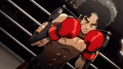 A Man In Red Boxing Gloves Is Standing In A Ring . GIF
