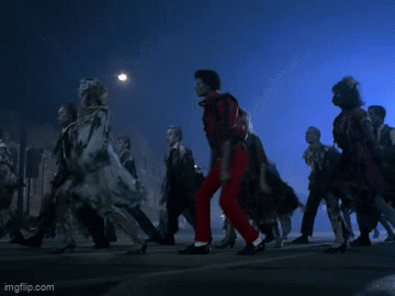 A Man In Red Pants Is Dancing In Front Of A Crowd Of People GIF