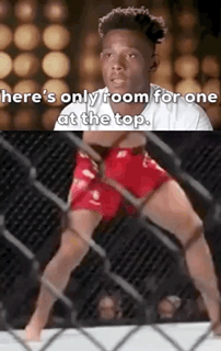 A Man In Red Shorts Is Standing In A Cage With The Words `` Here 'S Only Room For One At The Top '' . GIF