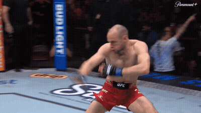 A Man In Red Shorts That Say Ufc Is Dancing On A Boxing Ring GIF