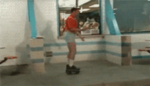 A Man In Shorts Is Rollerblading In A Fast Food Restaurant GIF