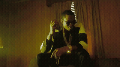 A Man In Sunglasses Is Holding A Bunch Of Money In His Hand GIF