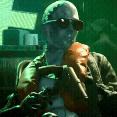 A Man In Sunglasses Is Holding A Gun GIF