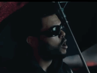 A Man In Sunglasses Is Smoking A Cigarette In A Car GIF