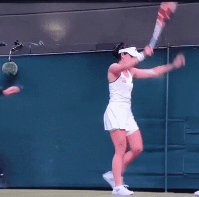 A Man In Sunglasses Is Standing Next To A Woman In A White Dress On A Tennis Court GIF