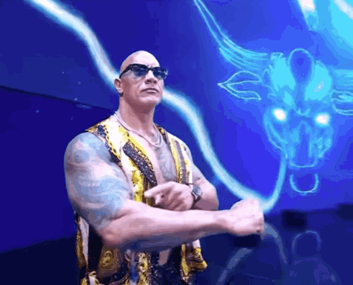 A Man In Sunglasses Stands In Front Of A Blue Bull GIF