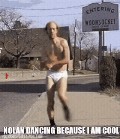 A Man In Underwear Is Running Down The Street . GIF