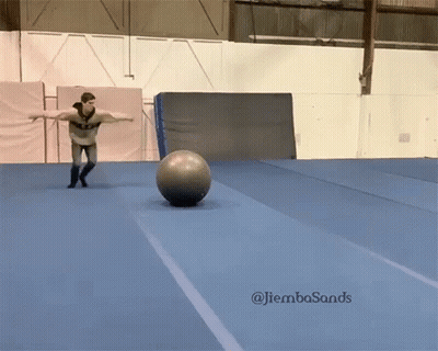 A Man Is Balancing A Ball On A Blue Mat With The Hashtag Jiembasands On The Bottom Right GIF