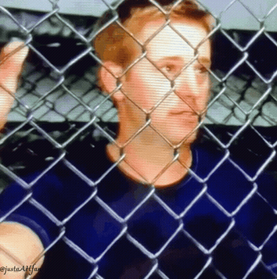 A Man Is Behind A Chain Link Fence And The Caption Says Justaafffan GIF