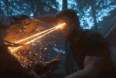 A Man Is Being Attacked By A Monster With A Light Coming Out Of His Eyes GIF