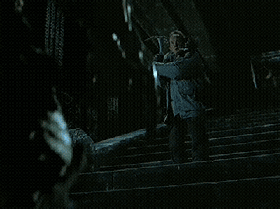 A Man Is Being Attacked By A Predator In A Movie Scene GIF