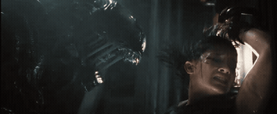 A Man Is Being Attacked By An Alien In A Movie GIF