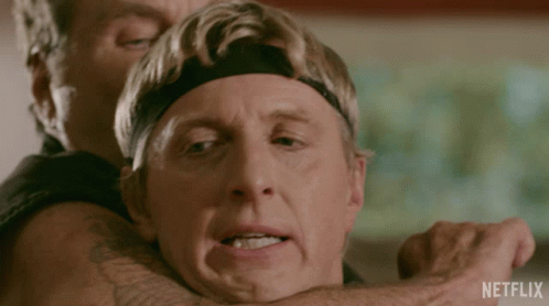 A Man Is Being Held By Another Man With A Netflix Logo In The Corner GIF