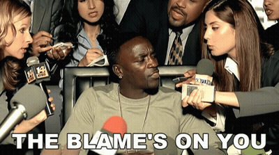 A Man Is Being Interviewed By A Group Of Reporters With The Words The Blame 'S On You Below Him GIF