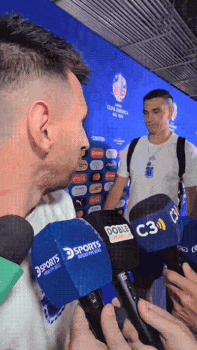 A Man Is Being Interviewed By Several Microphones Including A Sports One GIF