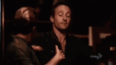 A Man Is Being Touched By Another Man 'S Hand GIF