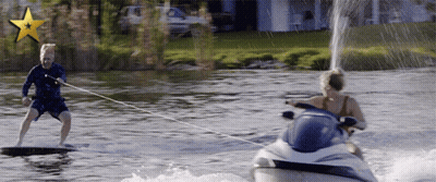 A Man Is Being Towed By A Jet Ski GIF