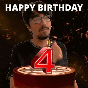 A Man Is Blowing Out A Number Four Candle On A Cake GIF