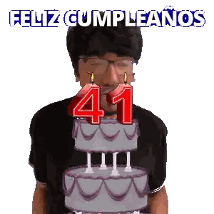 A Man Is Blowing Out Candles On A Cake With The Number 41 On It Sticker