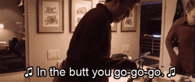 A Man Is Brushing His Teeth In Front Of A Mirror With The Words In The Butt You Go-Go-Go GIF
