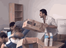 A Man Is Carrying A Box That Says Hp On The Front GIF