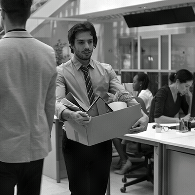 A Man Is Carrying A Cardboard Box With His Belongings GIF
