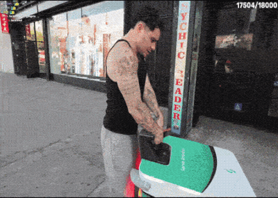 A Man Is Carrying A Green Surfboard In Front Of A Store Called Psychic Reader GIF