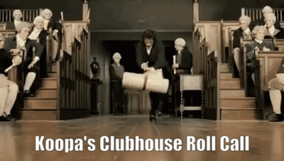 A Man Is Carrying A Roll Of Paper In Front Of A Group Of People Sitting On Stairs .. GIF