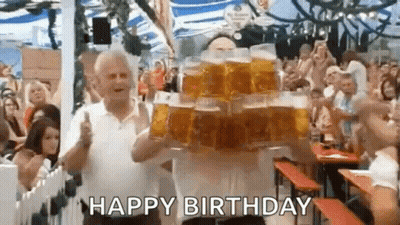 A Man Is Carrying A Stack Of Beer Mugs On His Stomach . GIF