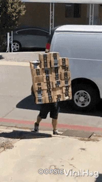 A Man Is Carrying A Stack Of Boxes On His Back And Says Oopsie Viralhog On The Bottom GIF