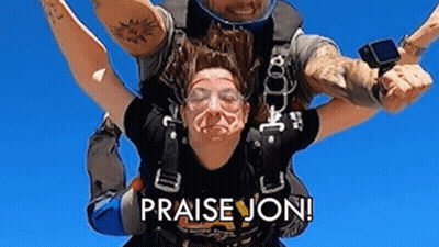 A Man Is Carrying A Woman In The Air With The Words `` Praise Jon '' On The Bottom . GIF