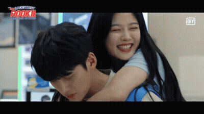 A Man Is Carrying A Woman On His Back With The Word Rookie On The Bottom Left GIF