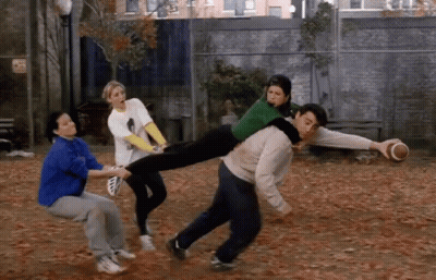 A Man Is Carrying A Woman On His Shoulders While A Group Of People Watch GIF