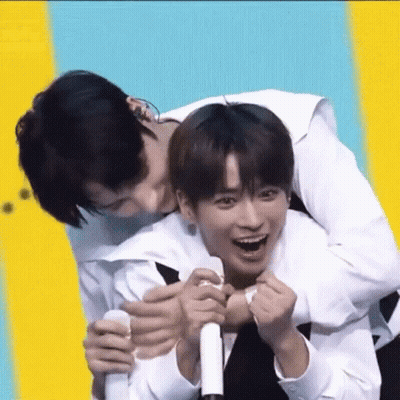 A Man Is Carrying Another Man On His Back And They Are Laughing . GIF