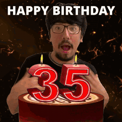 A Man Is Celebrating His 35Th Birthday By Blowing Out A Candle GIF
