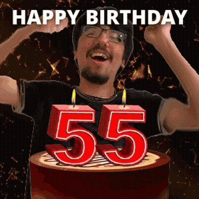 A Man Is Celebrating His 55Th Birthday By Blowing Out Candles On A Cake GIF