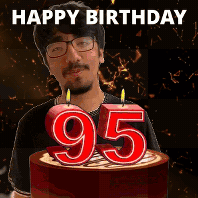 A Man Is Celebrating His 95Th Birthday By Blowing Out Candles On A Cake GIF