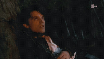 A Man Is Chained To A Tree With The Words Jane Is The Reason Below Him GIF