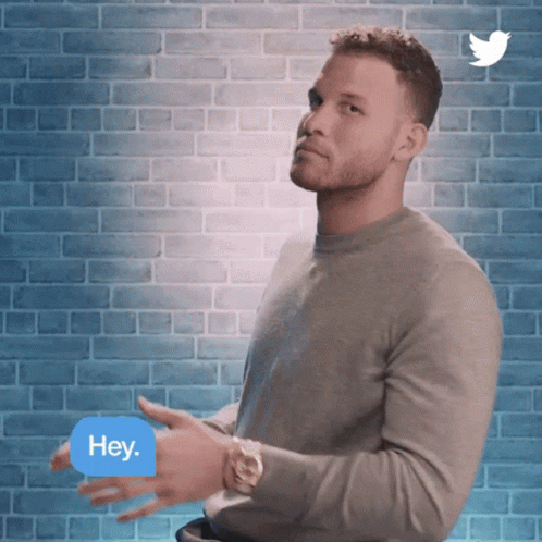 A Man Is Clapping In Front Of A Brick Wall With A Twitter Logo Behind Him GIF