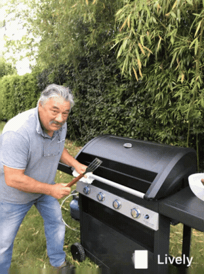 A Man Is Cleaning A Grill With A Spatula And The Word Lively Is Visible GIF