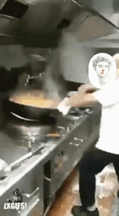 A Man Is Cooking Food In A Kitchen With A Picture Of A Statue Of A Woman On The Wall . GIF