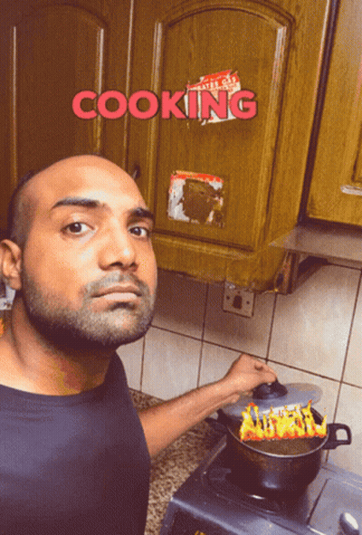A Man Is Cooking In Front Of A Cabinet That Says Cooking On It GIF