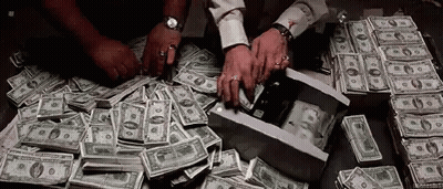 A Man Is Counting Money On A Table . GIF