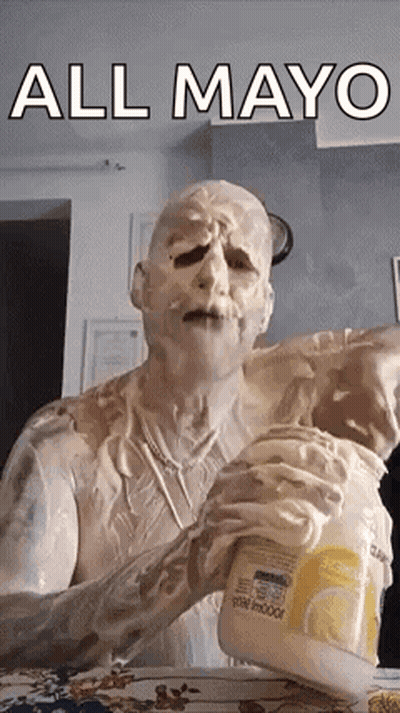A Man Is Covered In Mayonnaise And Is Holding A Bottle Of Mayonnaise . GIF