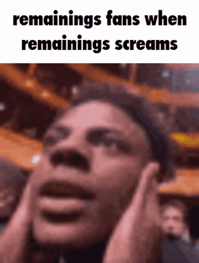 A Man Is Covering His Ears With His Hands While Screaming In Front Of A Crowd . GIF