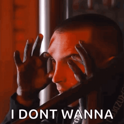 A Man Is Covering His Eyes With His Hands And The Words I Dont Wanna Are Below Him . GIF