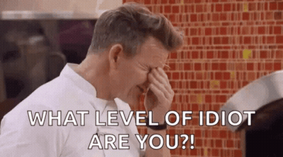 A Man Is Covering His Face With His Hand While Asking What Level Of Idiot Are You . GIF