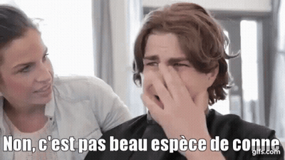 A Man Is Covering His Nose With His Hand While A Woman Looks On In A Salon . GIF