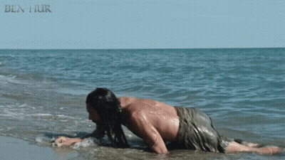 A Man Is Crawling In The Water With Ben Hur Written In The Corner GIF