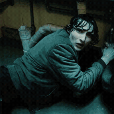 A Man Is Crawling Under A Sink With The Words " Are You By " Glowing On His Shirt GIF